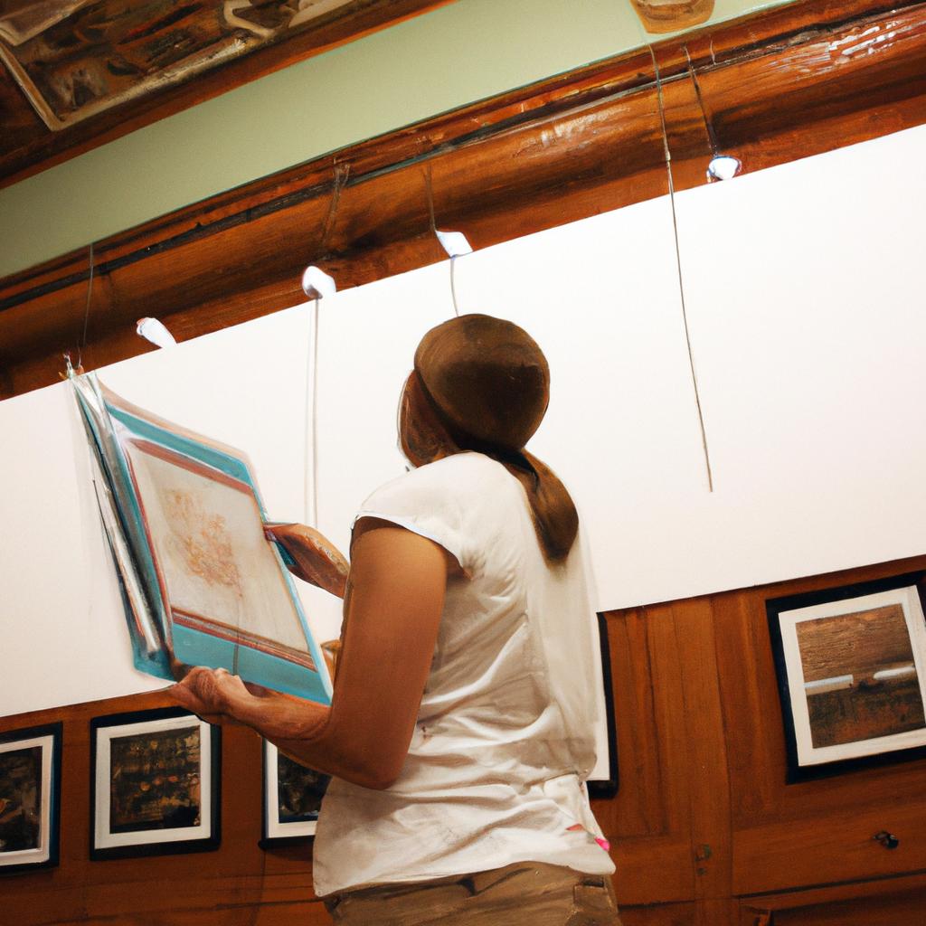 Person organizing artwork in museum