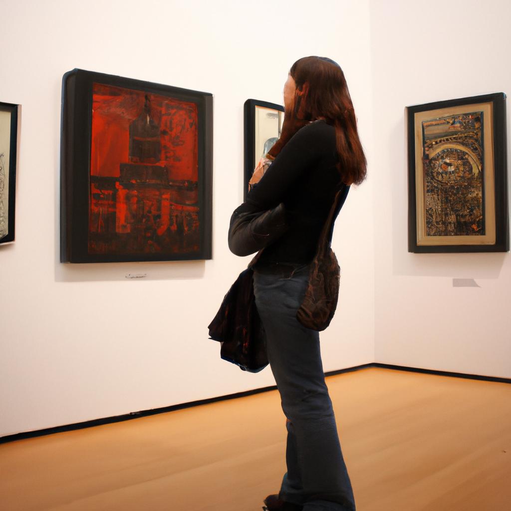 Person examining artwork in museum